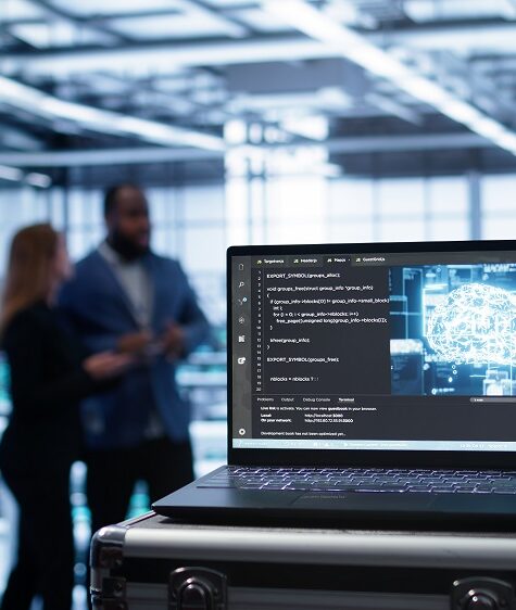 Laptop in data center facility with artificial intelligence computing simulating human brain, handheld camera shot. Close up of device displaying AI machine learning algorithms in server hub, camera B