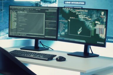Federal anti terrorism operation room equipped with a big screen and radar surveillance footage on satellite cctv system used for reconnaissance. Empty military command center.